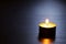 Single candle with back lit. Tranquil scene.