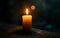 A single candle burning brightly in a dark room, casting a gentle glow. The candle symbolizes remembrance and awareness