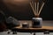 A single candle burns softly beside an elegant reed diffuser on a rustic wooden slab, smooth stones and a dark, textured