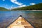 A single canoe on a mountain lake