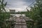 Single chair on Old wooden bridge on the lake, Cloudy day