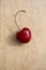 Single cherry on wood