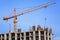 Single construction crane at the construction of monolithic apartment building