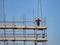 Single construction worker on construction site scaffolding