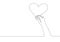 Single continuous line drawing of young happy female hand holding cute heart shaped carton paper. Romantic marriage love concept