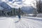 Single cross country skier on groomed ski track.