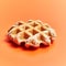 Single delicious waffle over orange background