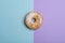 Single donut on a blue-violet background. Minimalism flat lay image