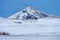 Single dramatic symetrical volcanic,snow covered cone near lake Myvatn, Iceland