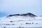 Single dramatic symetrical volcanic,snow covered crater near lake Myvatn, Iceland