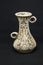 Single earthenware vase on dark background. Traditional pottery, a vase for flowers.