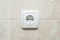 Single electric European wall socket with marble tiles