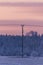 Single electrical pillar in front of frozen trees