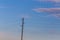 Single electricity pole with wires on the blue sky background.