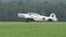 Single engine airplane on a grass runway