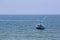 Single fishery boat floating on sea