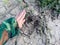 Single footprint of an elk in very deep and dried up mud in the ground in scale of woman`s hand next to it