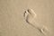 Single footprint on a sandy beach