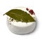 Single French goat cheese with herbs,bay laurel, red peppercorns and olive oil on white background