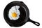 Single fried egg in cast iron frying pan sprinkled with ground b