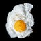 Single fried egg sprinkled with ground black pepper isolated on