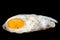Single fried egg sprinkled with ground black pepper isolated on