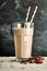 Single glass of chocolate smoothie on marble table