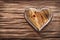 Single glossy wooden heart on vintage wood