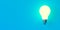 Single glowing light bulb over blue background with copy space, invention or innovation concept