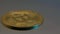 single golden Bitcoin coin rotates close up