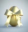 Single golden painted easter egg with bow