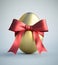 Single golden painted easter egg with bow