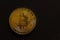 single golden shiny valuable bitcoin front view with black left