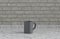 Single gray olor coffee mug on a front view kitchen counter top with gray tiled brick wall, 3d Rendering, close-up view