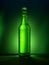 Single green beer bottle with water drops against green illuminated background