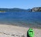 A single green kayak resting by itself along the beautiful waters in Bonne Bay, in Gros Morne National Park, Newfoundland