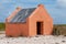 Single historic red slave hut in Bonaire, Caribbean
