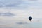 Single hot air balloon against a beautiful summer sky