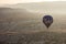 Single Hot air balloons in the sky during sunrise. Flying over colourful rock formations in Cappadocia, Turkey in Goreme