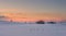 Single hut at sunset in winter at snowy meadow