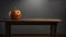 Single Jack lantern on table. Gray background. Element of Halloween decoration