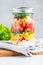 Single jar with layering vegan salad for healthy lunch