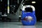 Single kettlebell on the gym floor ready to use for strength and conditioning training sport concept