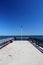 Single Lantern at the end of a landing stage on a clear blue sky