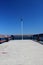 Single Lantern at the end of a landing stage on a clear blue sky