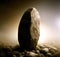 Single large Standing stone in barren landscape. Solitary Strength concept