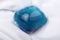 Single laundry detergent pod or pack on a white cloth