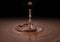 Single liquid chocolate drop splash in chocolate sauce pool