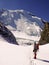 Single male mountain climber looks at a steep north face he has just climbed