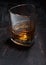 Single malt scotch whiskey in luxury crystal glass on wooden background